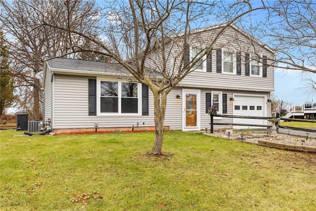 view of front of home featuring central AC, a front lawn, and a garage