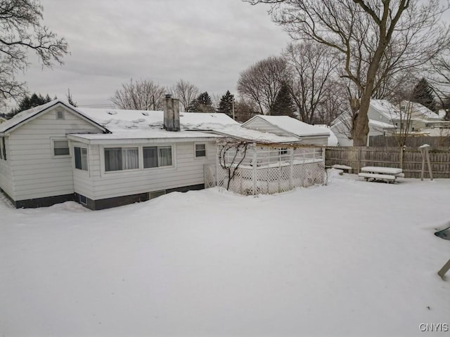 view of snow covered rear of property