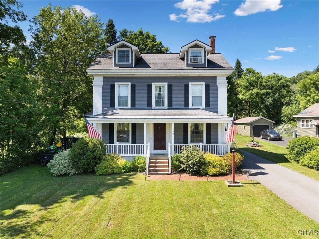 view of front of house with a front yard and a porch