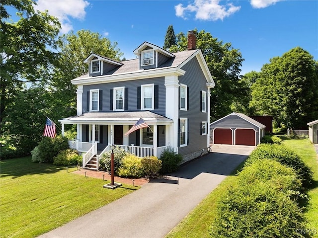 view of front of house with a porch, a garage, a front lawn, and an outdoor structure