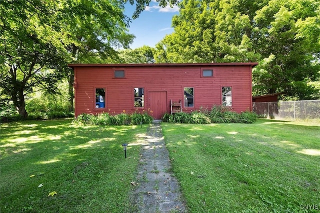 view of outbuilding with a lawn