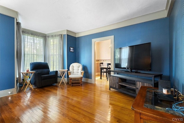 living room featuring wood-type flooring and ornamental molding