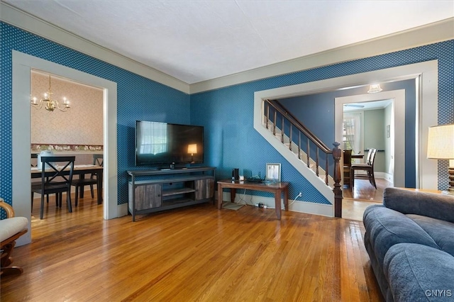 living room with a notable chandelier and wood-type flooring