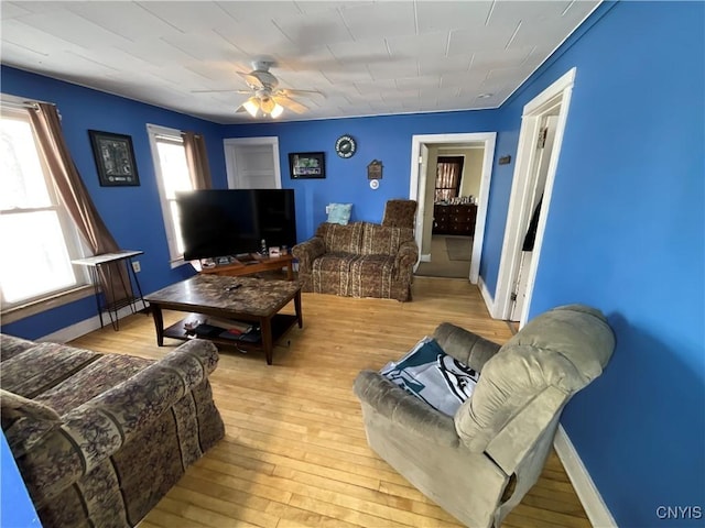 living room with ceiling fan and light wood-type flooring