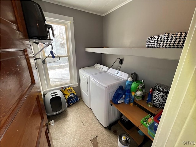 laundry room with crown molding and washer and clothes dryer