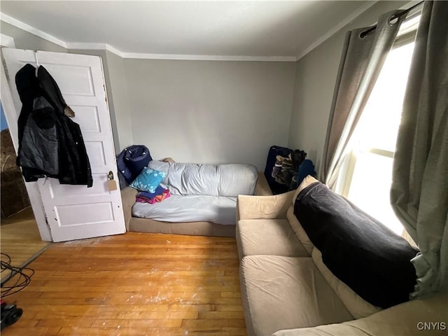 bedroom with light wood-type flooring and ornamental molding