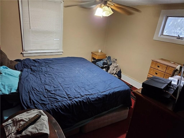 bedroom featuring ceiling fan and ornamental molding