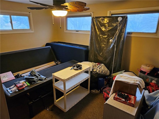 bedroom featuring dark colored carpet and ceiling fan