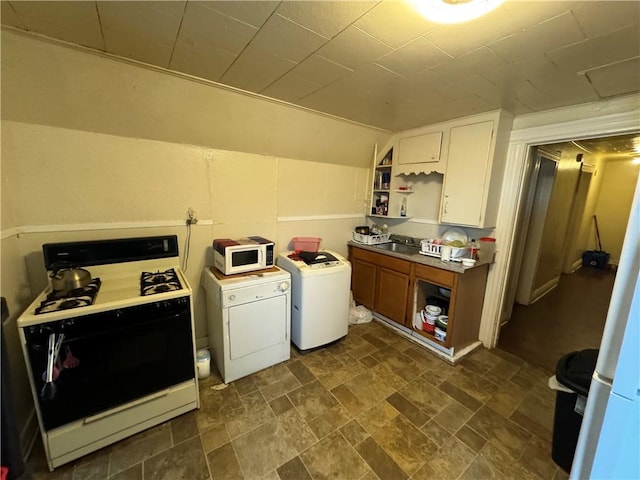 washroom with independent washer and dryer and sink