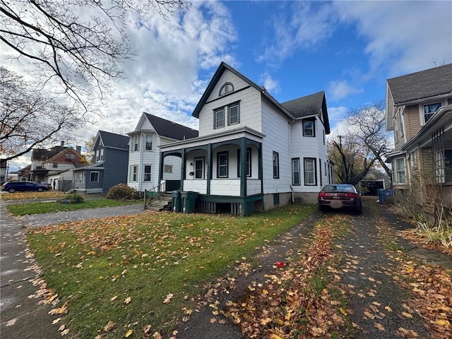 view of front of property with a porch and a front yard