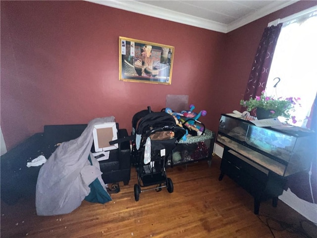 bedroom with hardwood / wood-style floors and ornamental molding