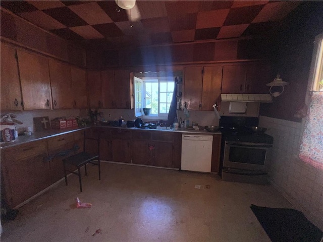 kitchen with white dishwasher and black gas range oven