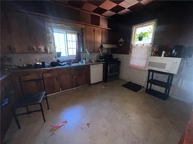 kitchen featuring white appliances and plenty of natural light