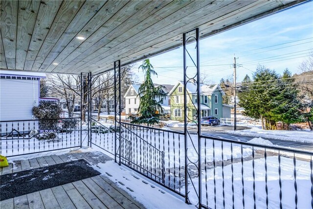 snow covered deck with covered porch