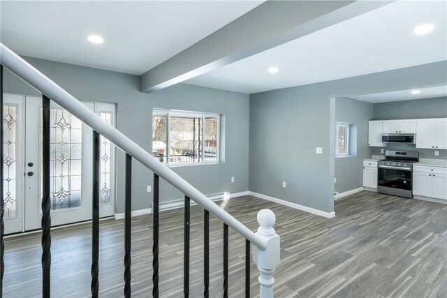 staircase with hardwood / wood-style flooring and beam ceiling