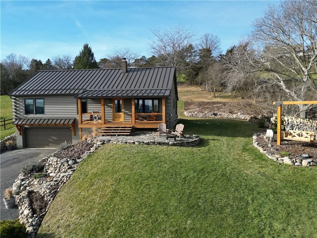 view of front of property with a garage, a front lawn, and a wooden deck