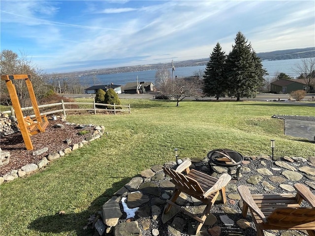 view of yard featuring a water view and a fire pit