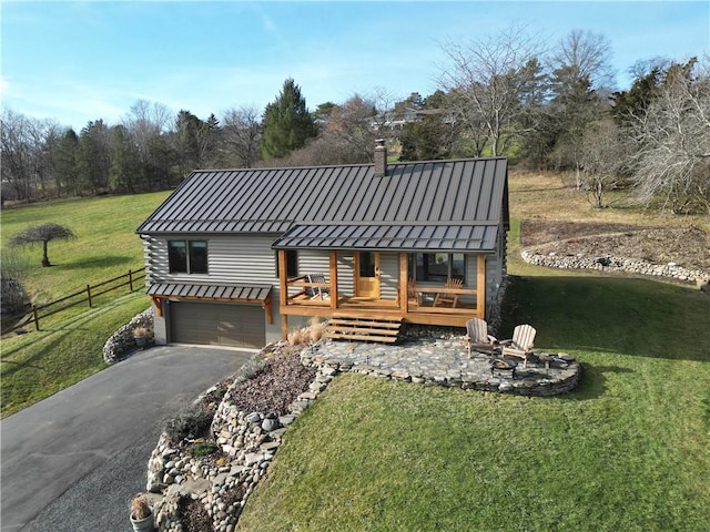 view of front facade featuring a garage, a front lawn, and a wooden deck