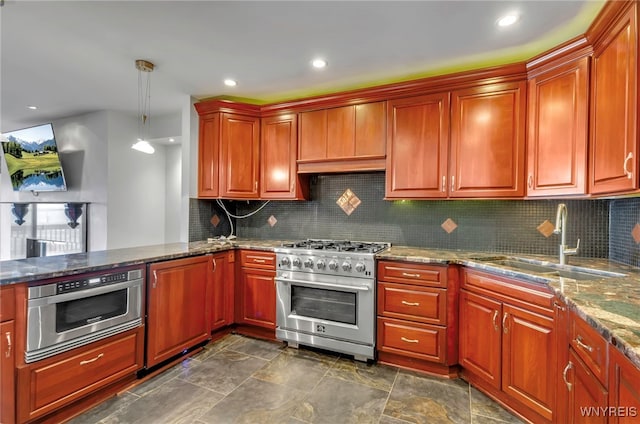 kitchen featuring light stone countertops, appliances with stainless steel finishes, decorative light fixtures, sink, and backsplash