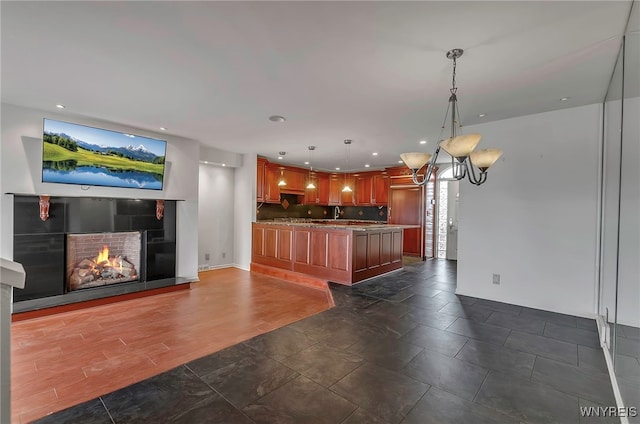 kitchen featuring dark wood-type flooring, pendant lighting, and tasteful backsplash