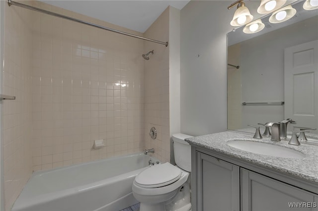 full bathroom with vanity, toilet, and tiled shower / bath