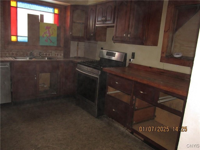 kitchen featuring dark brown cabinets, sink, and stainless steel range with gas stovetop