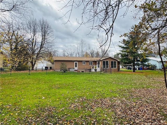 rear view of house with a yard