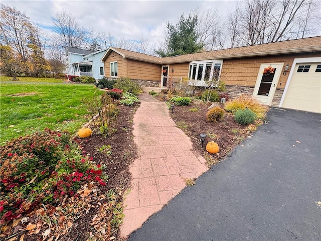 single story home with a garage and a front yard