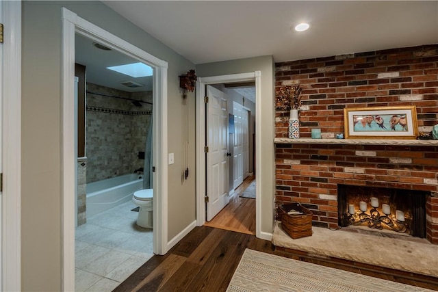 hallway with dark hardwood / wood-style flooring