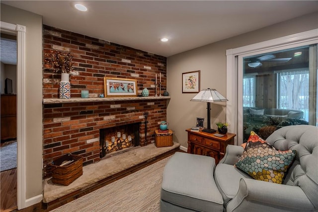 living room with hardwood / wood-style flooring and a fireplace