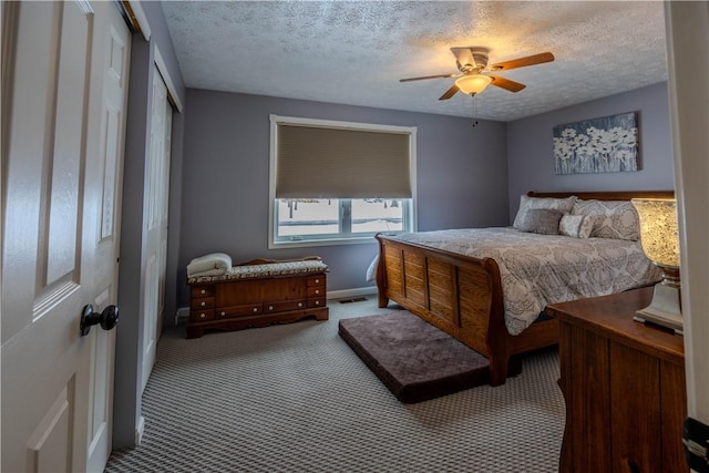 carpeted bedroom with ceiling fan and a textured ceiling