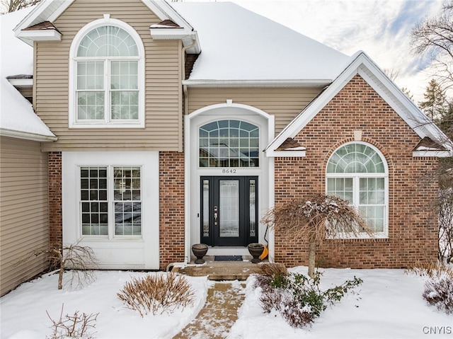 view of snow covered property entrance