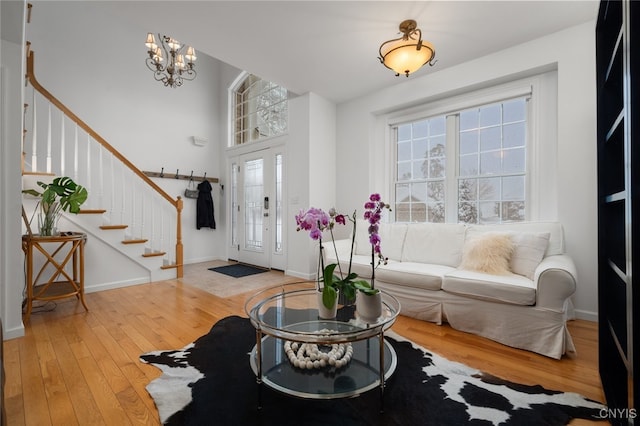 foyer with wood-type flooring and a chandelier