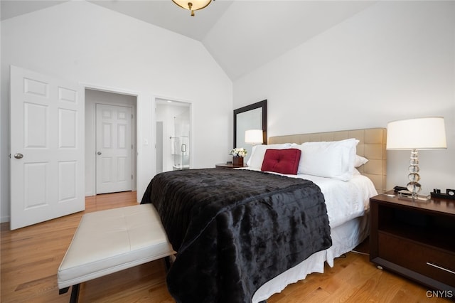 bedroom featuring light hardwood / wood-style floors and lofted ceiling