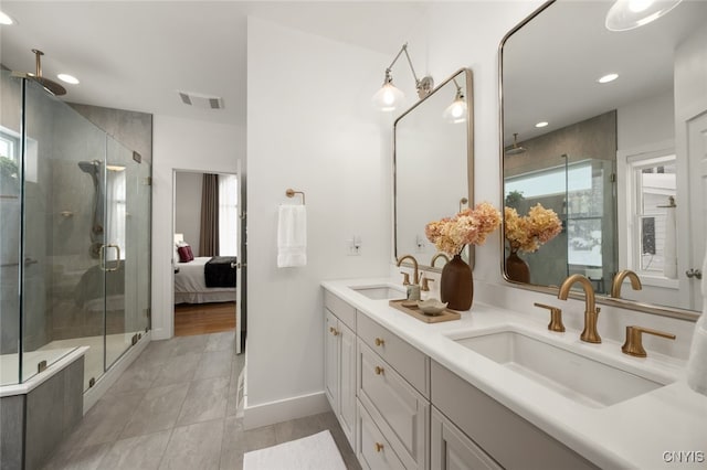 bathroom with vanity, plenty of natural light, and a shower with shower door