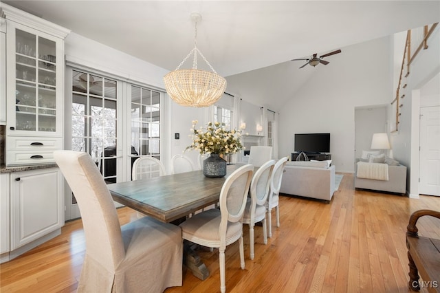 dining area featuring plenty of natural light, light hardwood / wood-style floors, and ceiling fan with notable chandelier