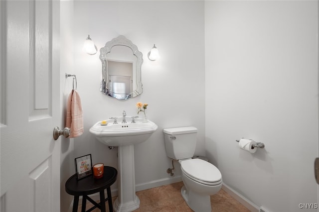 bathroom with tile patterned floors, sink, and toilet