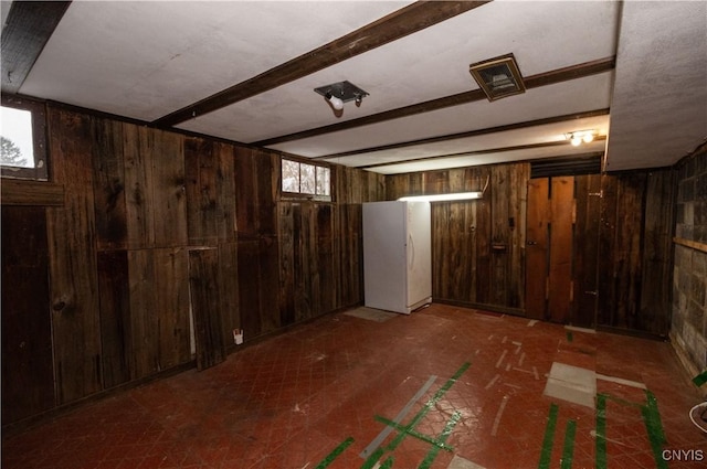 basement featuring wooden walls