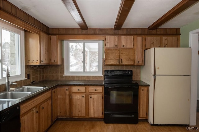 kitchen with black appliances, sink, light hardwood / wood-style flooring, beamed ceiling, and a healthy amount of sunlight