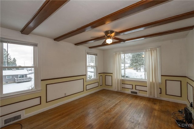 additional living space featuring hardwood / wood-style flooring, ceiling fan, and beamed ceiling