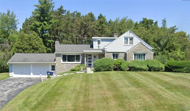 view of front of property featuring a garage and a front yard