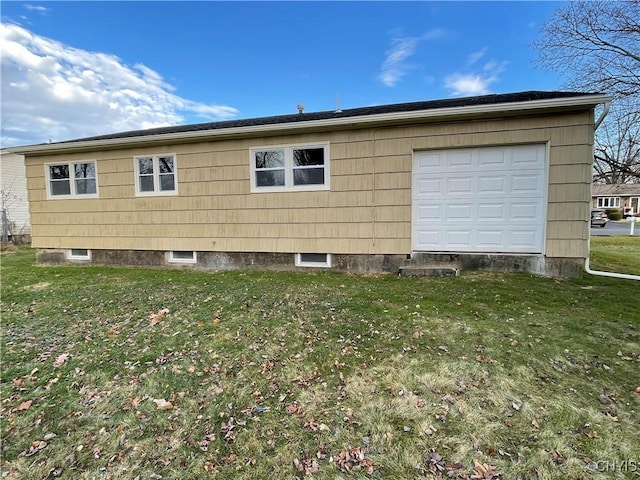 view of home's exterior with a lawn and a garage