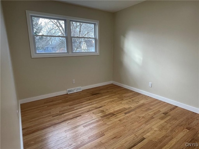 empty room with light hardwood / wood-style flooring