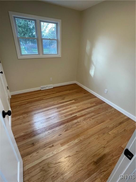 unfurnished room featuring light hardwood / wood-style flooring