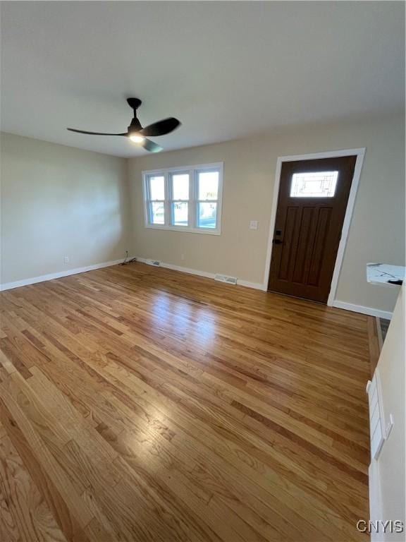 entryway featuring a wealth of natural light, ceiling fan, and light wood-type flooring