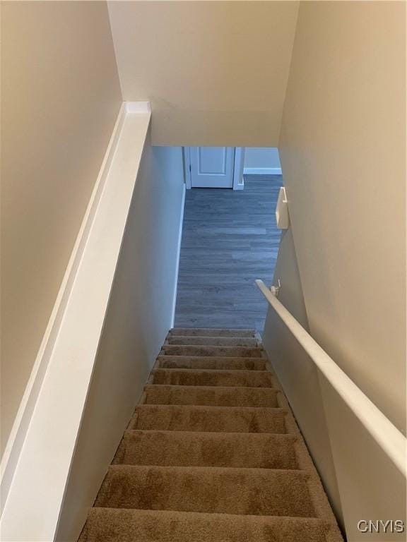 stairs featuring hardwood / wood-style floors