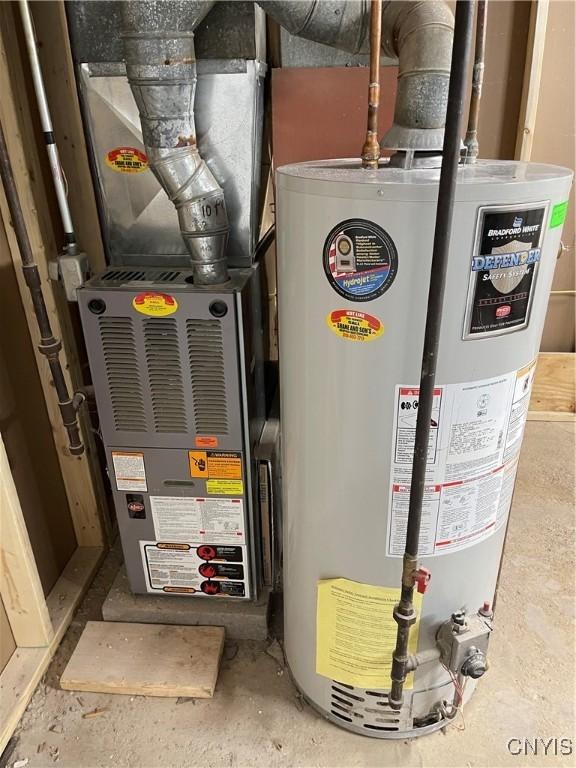 utility room with heating unit and gas water heater