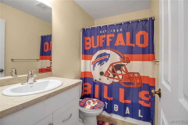 bathroom with tile patterned flooring, vanity, curtained shower, and toilet