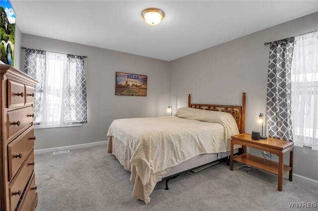 bedroom featuring light carpet