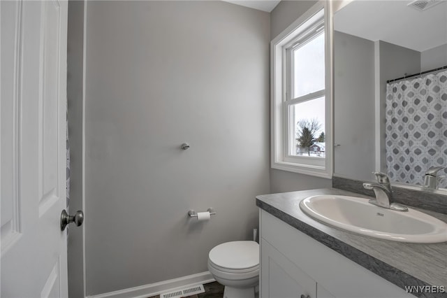 bathroom featuring vanity and toilet